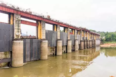 Picture of a dam construction taking place atop a river