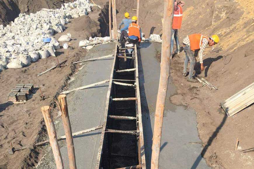 Workers working on a diaphragm wall construction for a waterfront development project