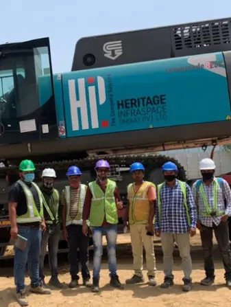 People standing with helmets and construction uniforms